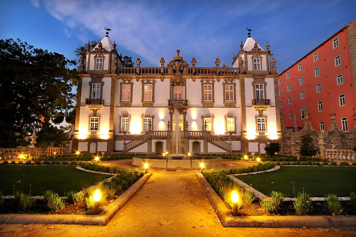 Baroque Palácio do Freixo lit at dusk with its fountain and garden in Porto