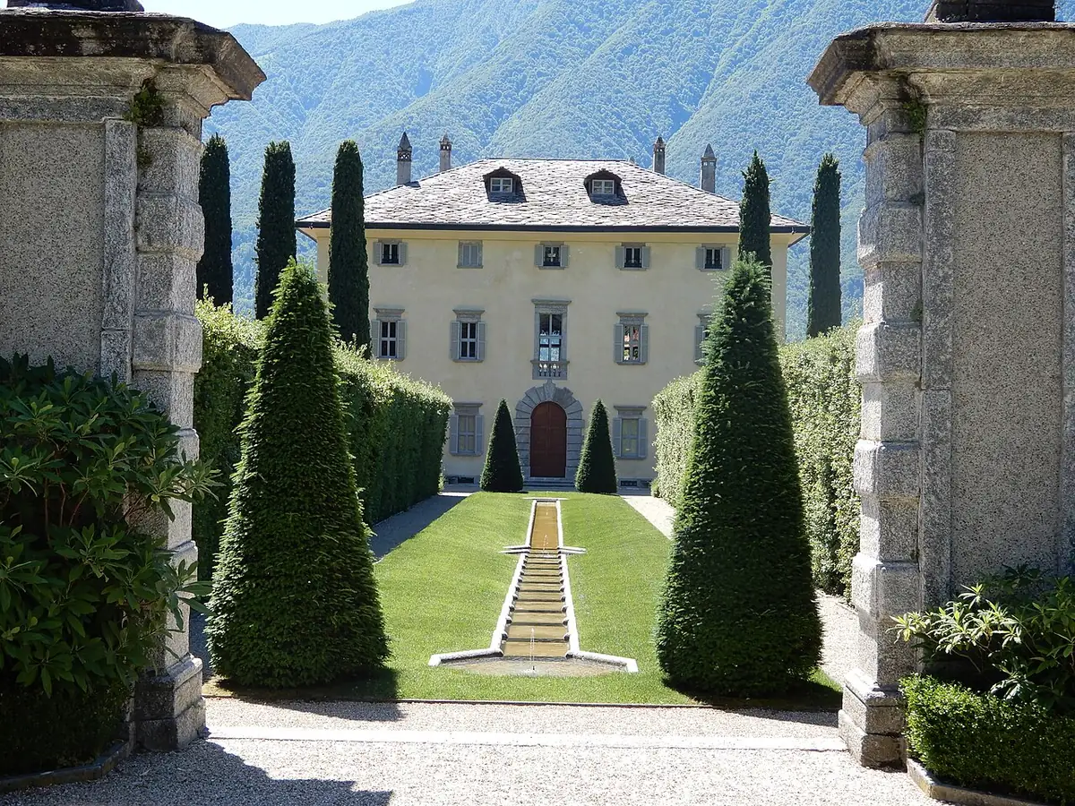 Villa Balbiano seen through its gate piers and clipped cypresses on Lake Como