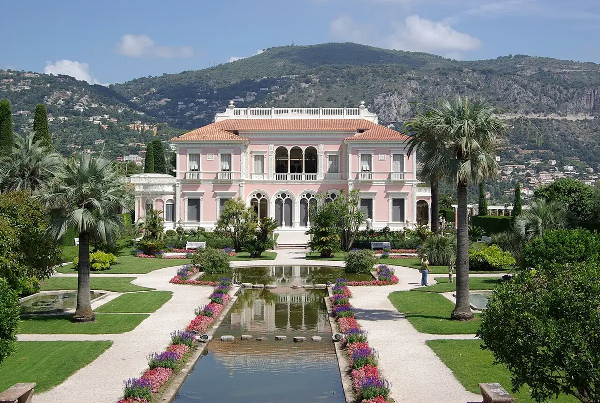 Pink Villa Ephrussi de Rothschild above its formal garden and pools