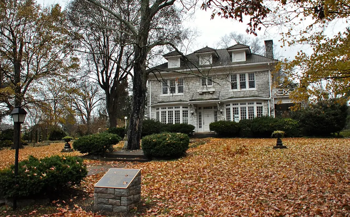 Stone Colonial Revival Stone Hall among autumn leaves in Nashville