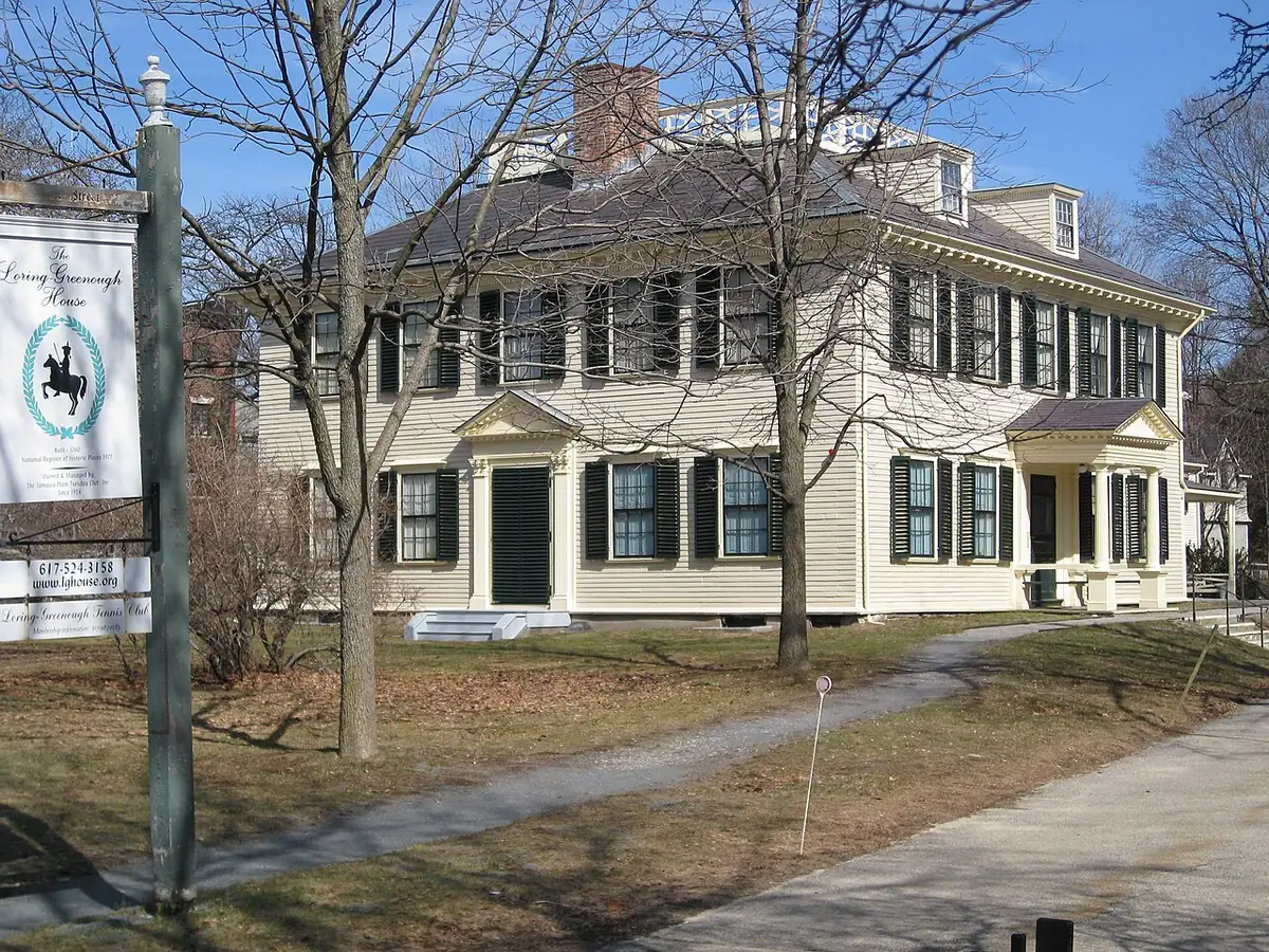 Pale yellow Georgian Loring Greenough House behind bare trees in Jamaica Plain